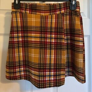 Plaid skort (gold, red, black). Size medium. Never worn